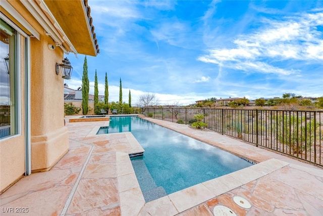 view of swimming pool featuring a jacuzzi, fence, a fenced in pool, and a patio