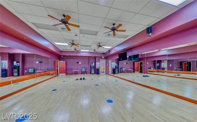 interior space with a drop ceiling and wood finished floors