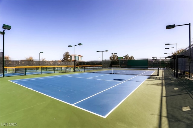 view of tennis court with fence