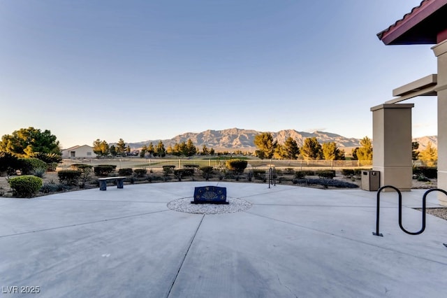 view of patio / terrace with an outdoor fire pit and a mountain view