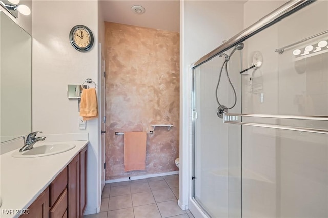 full bathroom featuring toilet, a stall shower, vanity, and tile patterned floors