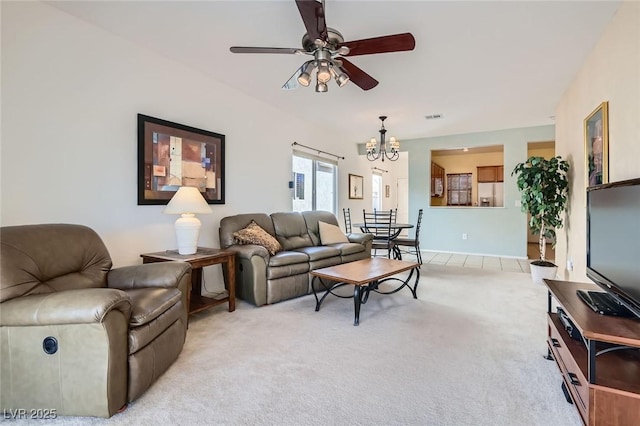 living room featuring light colored carpet, visible vents, and ceiling fan with notable chandelier