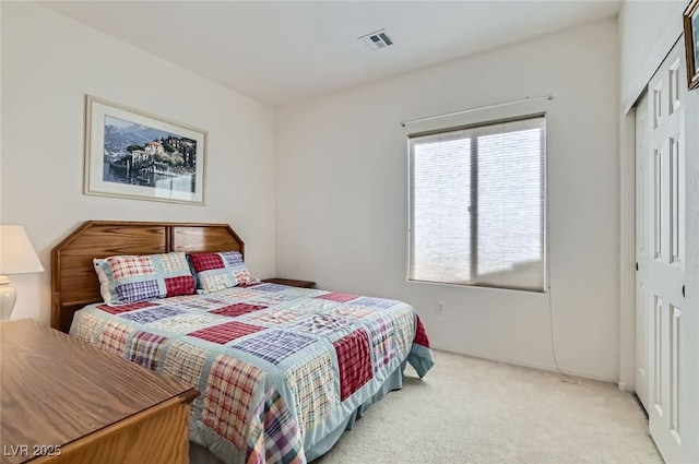 bedroom with carpet floors, a closet, and visible vents