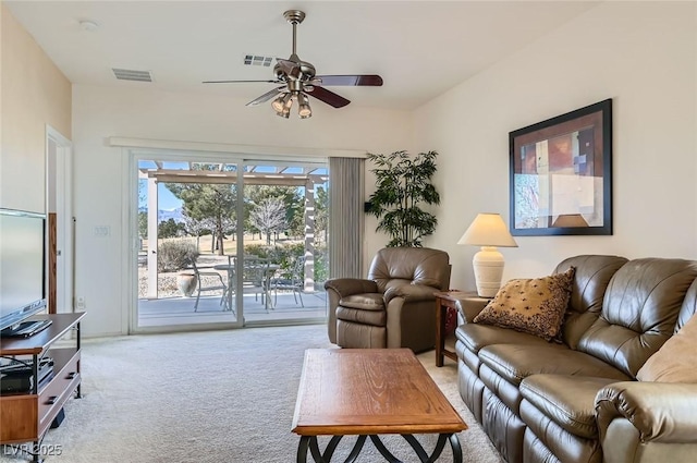 carpeted living room featuring a ceiling fan and visible vents