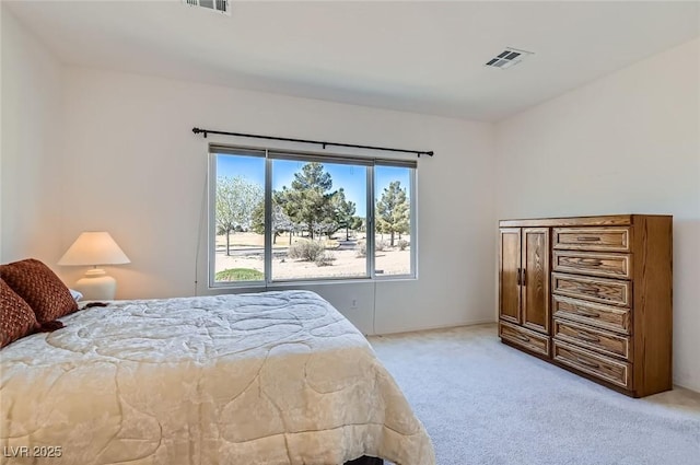 bedroom featuring light colored carpet and visible vents