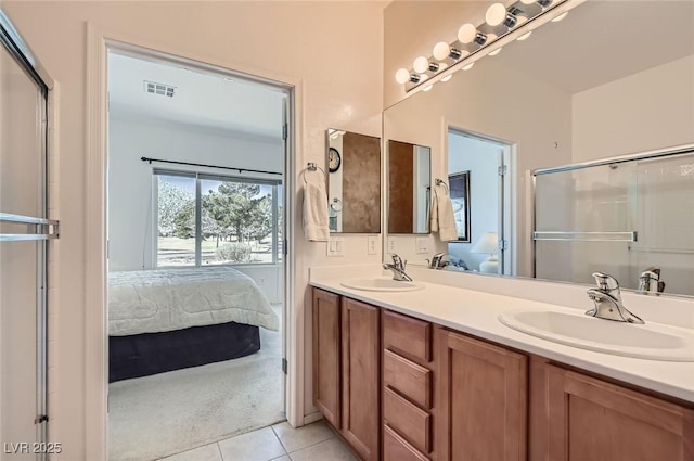 full bath with tile patterned floors, a sink, visible vents, and connected bathroom