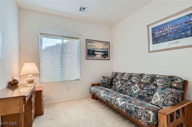 living room featuring light colored carpet, visible vents, and baseboards