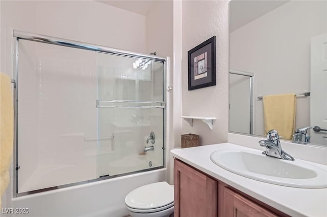 bathroom featuring toilet, vanity, and enclosed tub / shower combo