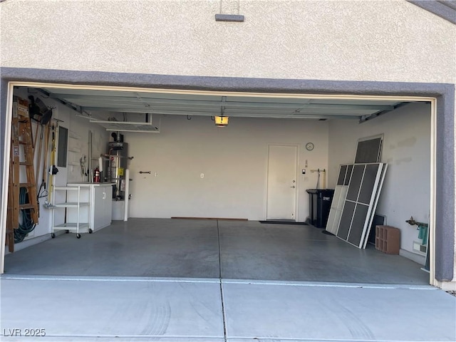 garage featuring a garage door opener, strapped water heater, and electric panel