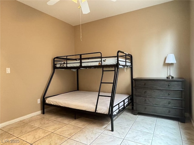 bedroom with ceiling fan and baseboards