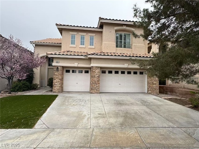 mediterranean / spanish home featuring stone siding, driveway, an attached garage, and stucco siding