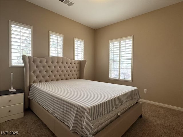 bedroom with carpet floors, multiple windows, visible vents, and baseboards