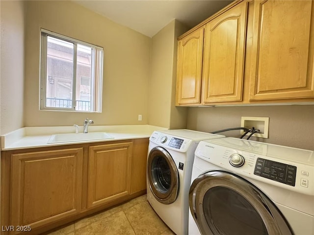 laundry room with cabinet space, light tile patterned floors, washer and clothes dryer, and a sink