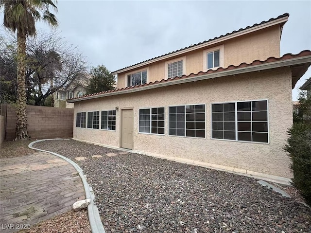 back of property with a patio area, fence, and stucco siding