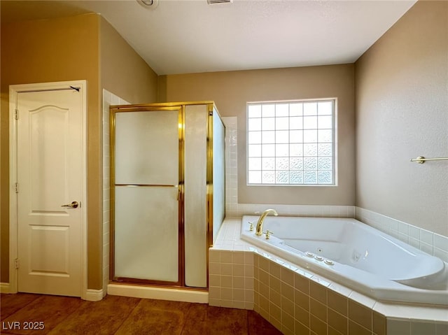 full bathroom featuring a jetted tub and a stall shower