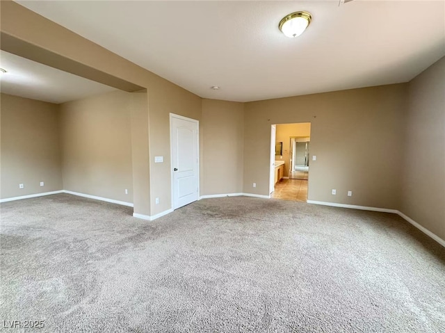 carpeted spare room with baseboards