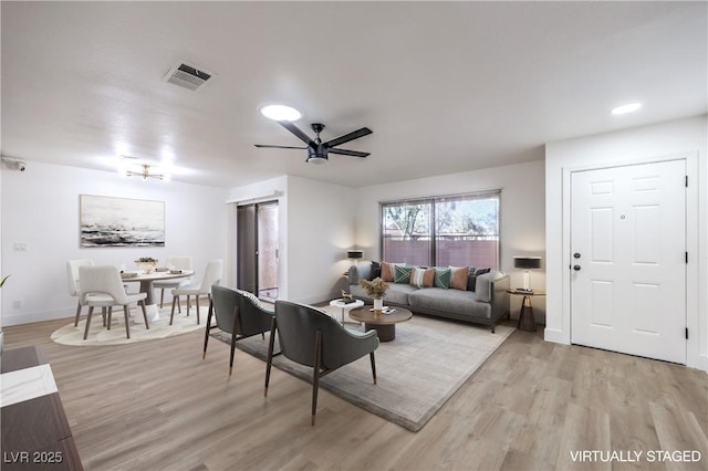 living room featuring light wood finished floors, recessed lighting, visible vents, ceiling fan, and baseboards