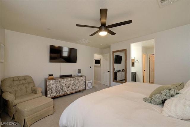 carpeted bedroom featuring ceiling fan, visible vents, and connected bathroom