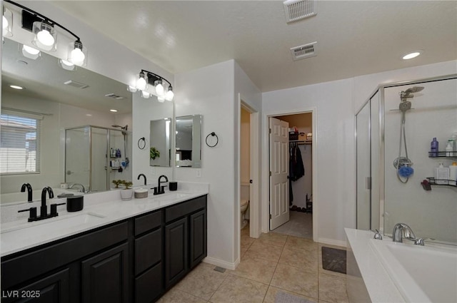 full bath with a bath, a shower stall, visible vents, and a sink