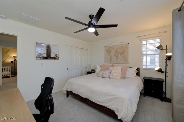 bedroom featuring light carpet, visible vents, baseboards, ceiling fan, and a closet