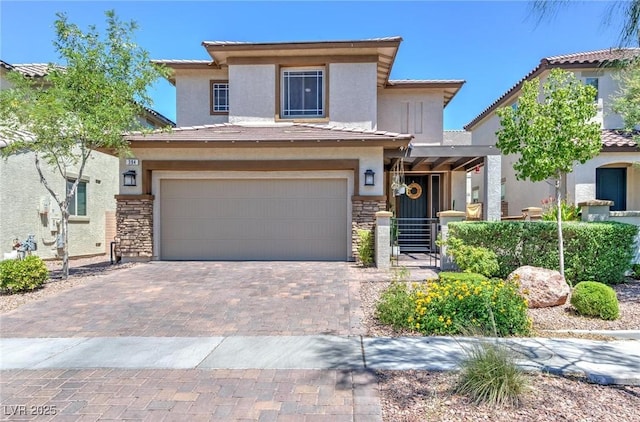 view of front of home with a garage, stone siding, a tiled roof, decorative driveway, and stucco siding