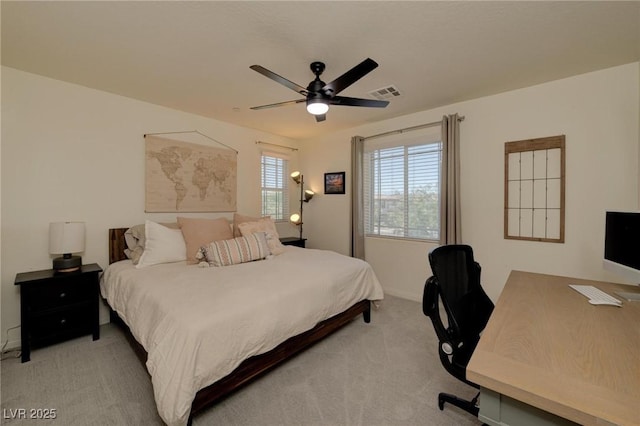 bedroom featuring light carpet, baseboards, visible vents, and a ceiling fan