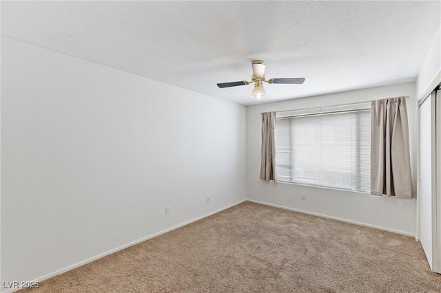 5265 Caspian Springs Dr Unit 201, Las Vegas, NV 89120 - spare room featuring carpet, baseboards, and a ceiling fan
