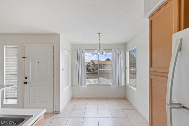 5265 Caspian Springs Dr Unit 201, Las Vegas, NV 89120 - unfurnished dining area featuring light tile patterned flooring and a chandelier