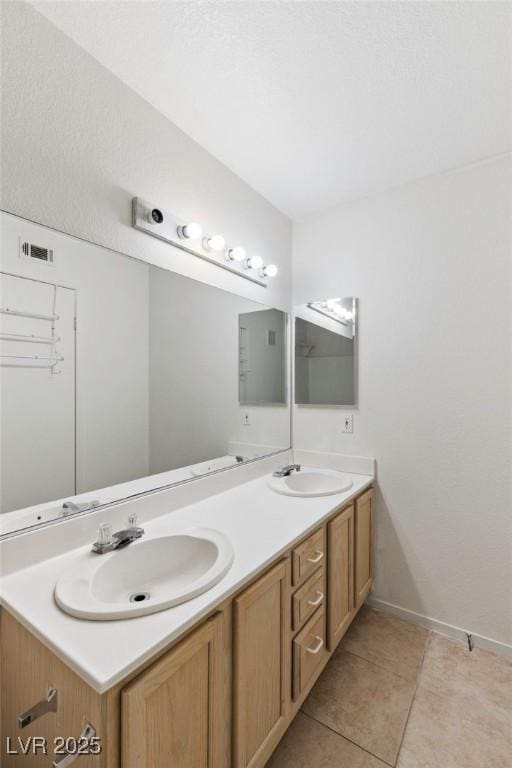 5265 Caspian Springs Dr Unit 201, Las Vegas, NV 89120 - full bath featuring double vanity, tile patterned floors, and baseboards
