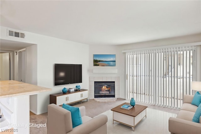 5265 Caspian Springs Dr Unit 201, Las Vegas, NV 89120 - living area featuring healthy amount of natural light, a tile fireplace, and light carpet
