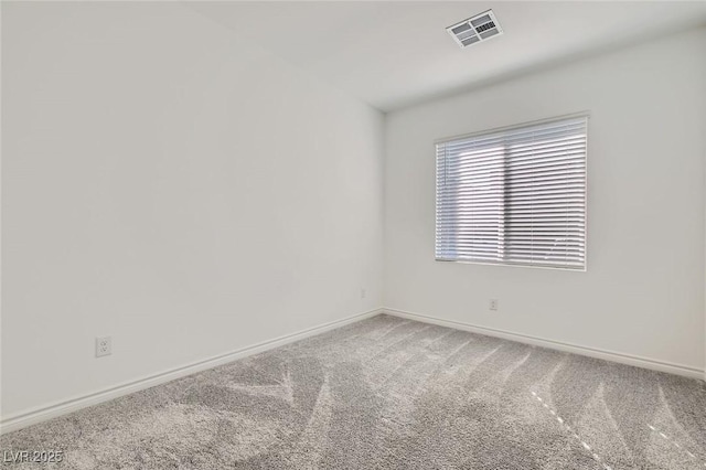 carpeted empty room with visible vents and baseboards