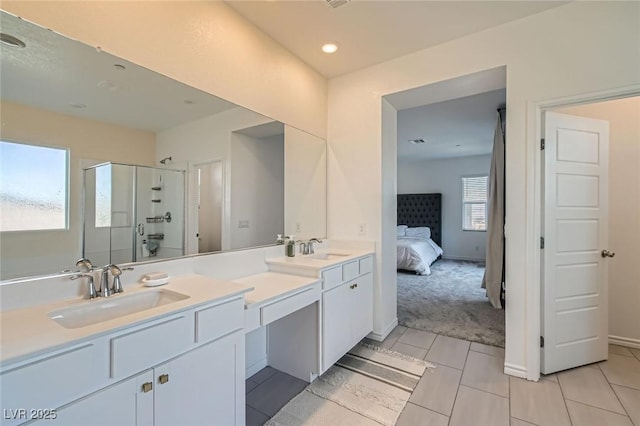 bathroom featuring a sink, a shower stall, ensuite bath, and double vanity