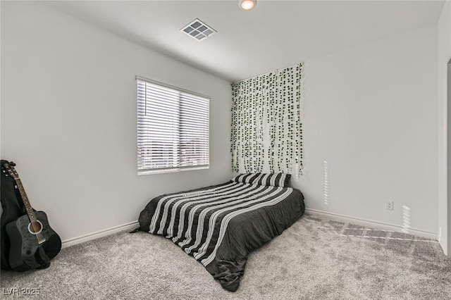 carpeted bedroom featuring visible vents and baseboards