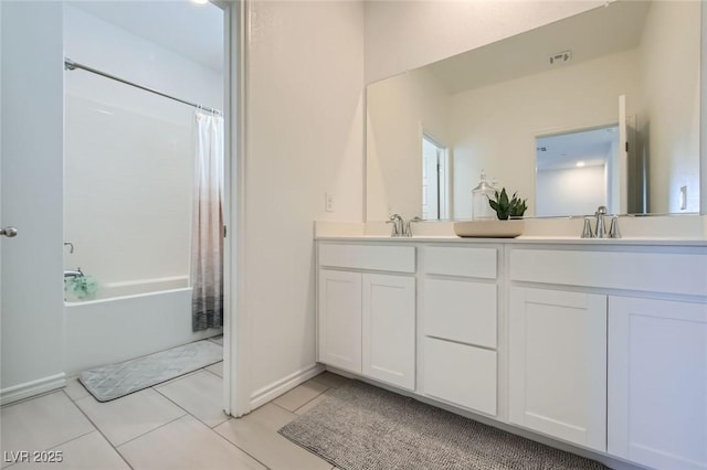 bathroom with double vanity, visible vents, tile patterned floors, shower / bath combo with shower curtain, and a sink