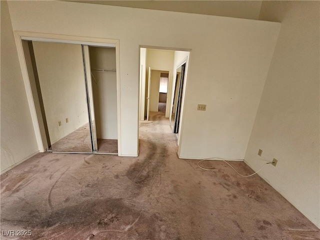 unfurnished bedroom featuring carpet floors and a closet