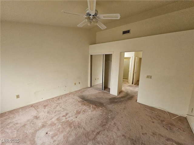 unfurnished bedroom featuring ceiling fan, a closet, carpet flooring, and visible vents