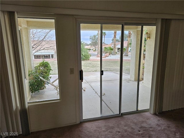 doorway featuring carpet flooring