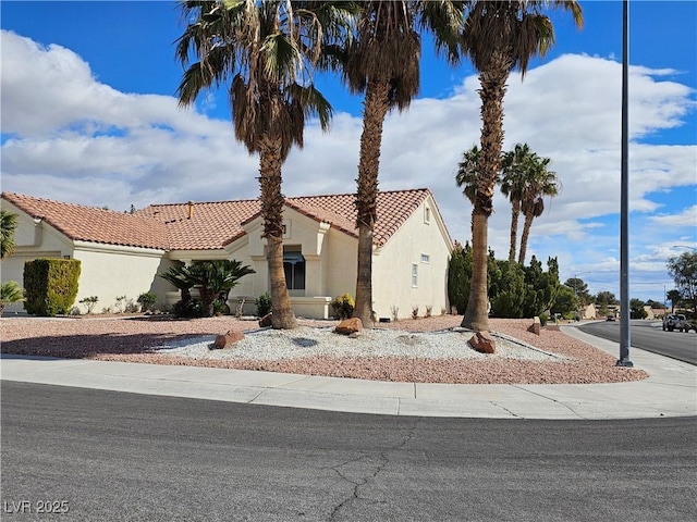 view of front of house with a tiled roof and stucco siding