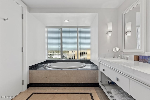 bathroom with tile patterned floors, a bath, and vanity