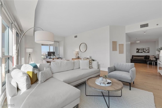 living room with visible vents and wood finished floors