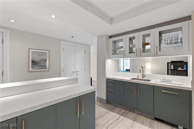 2700 Las Vegas Blvd Unit 1202, Las Vegas, NV 89109 - kitchen with gray cabinets, light countertops, recessed lighting, and glass insert cabinets