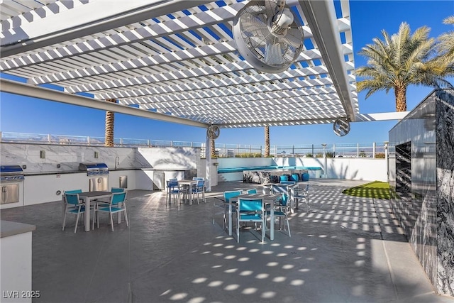 view of patio with an outdoor kitchen, grilling area, outdoor dining area, and a pergola