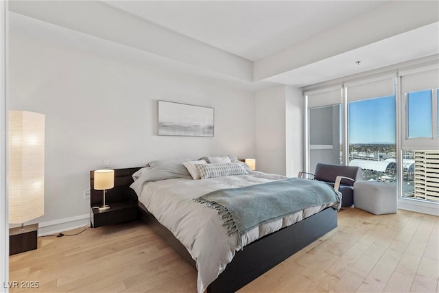 bedroom featuring light wood-type flooring and baseboards