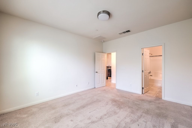 4542 Townwall St, Las Vegas, NV 89115 - unfurnished bedroom with light colored carpet, visible vents, ensuite bath, and baseboards