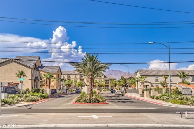 4542 Townwall St, Las Vegas, NV 89115 - view of road with street lighting, traffic signs, a residential view, and curbs