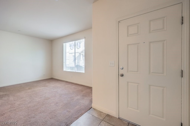 4542 Townwall St, Las Vegas, NV 89115 - foyer entrance with light carpet, baseboards, and light tile patterned floors