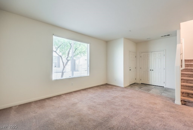 4542 Townwall St, Las Vegas, NV 89115 - unfurnished room featuring carpet, visible vents, baseboards, and stairs