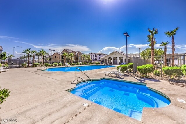 4542 Townwall St, Las Vegas, NV 89115 - community pool with a patio and fence