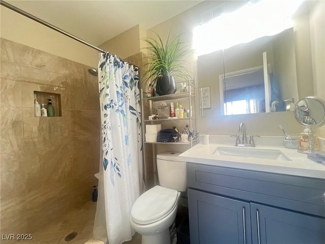 full bathroom with toilet, a tile shower, and vanity