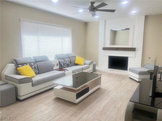 4194 Greenpoint St, Las Vegas, NV 89147 - living room with ceiling fan, light wood-style floors, recessed lighting, and a fireplace